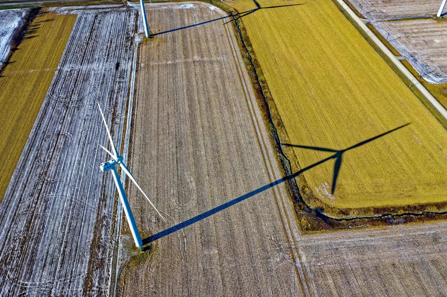 Illustrative scene, not evidence for this record: A wind turbine casting a shadow on farmland in Dodge Center, Minnesota.