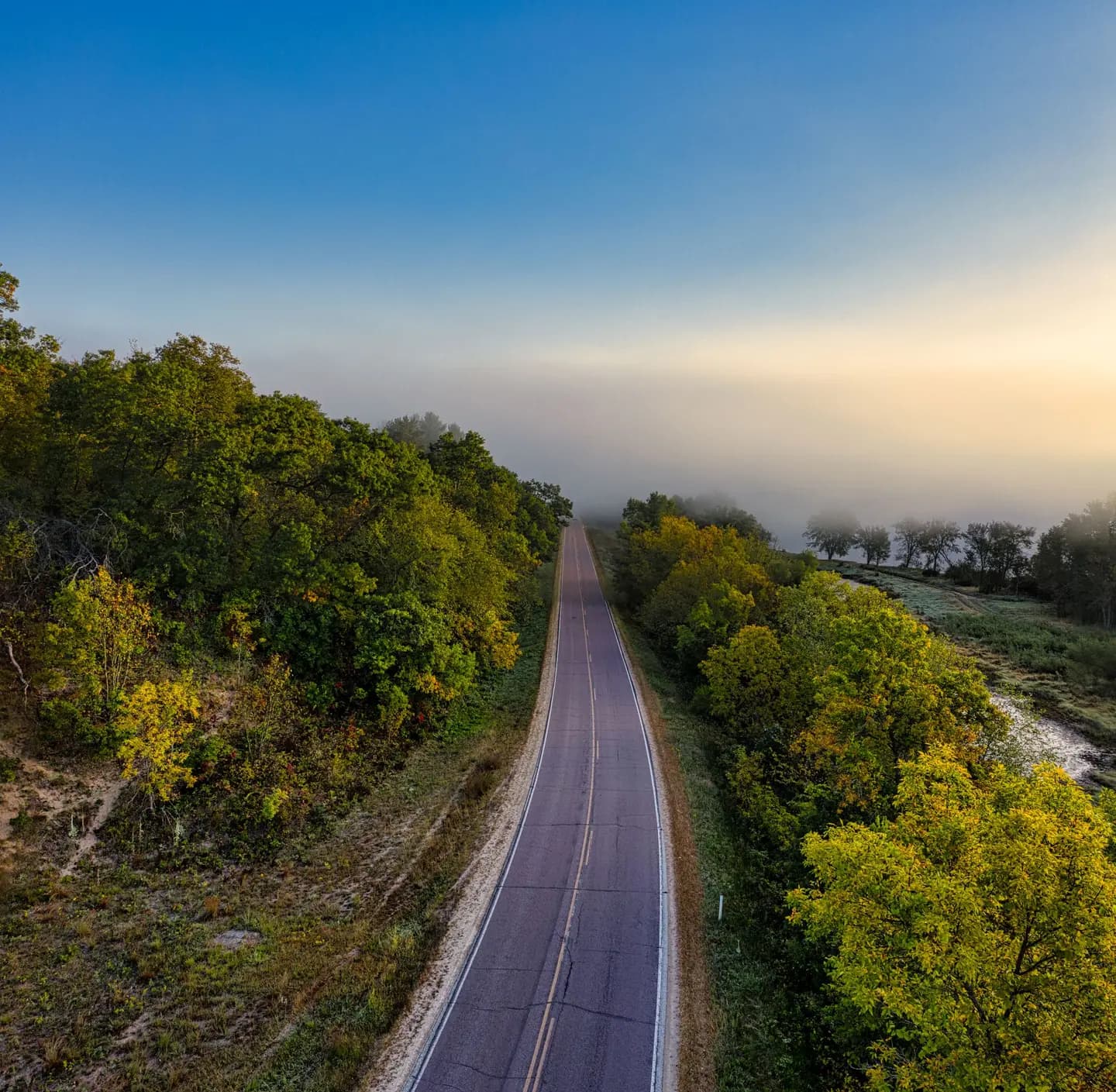 Illustrative scene, not evidence for this record: A foggy rural road in Wisconsin.