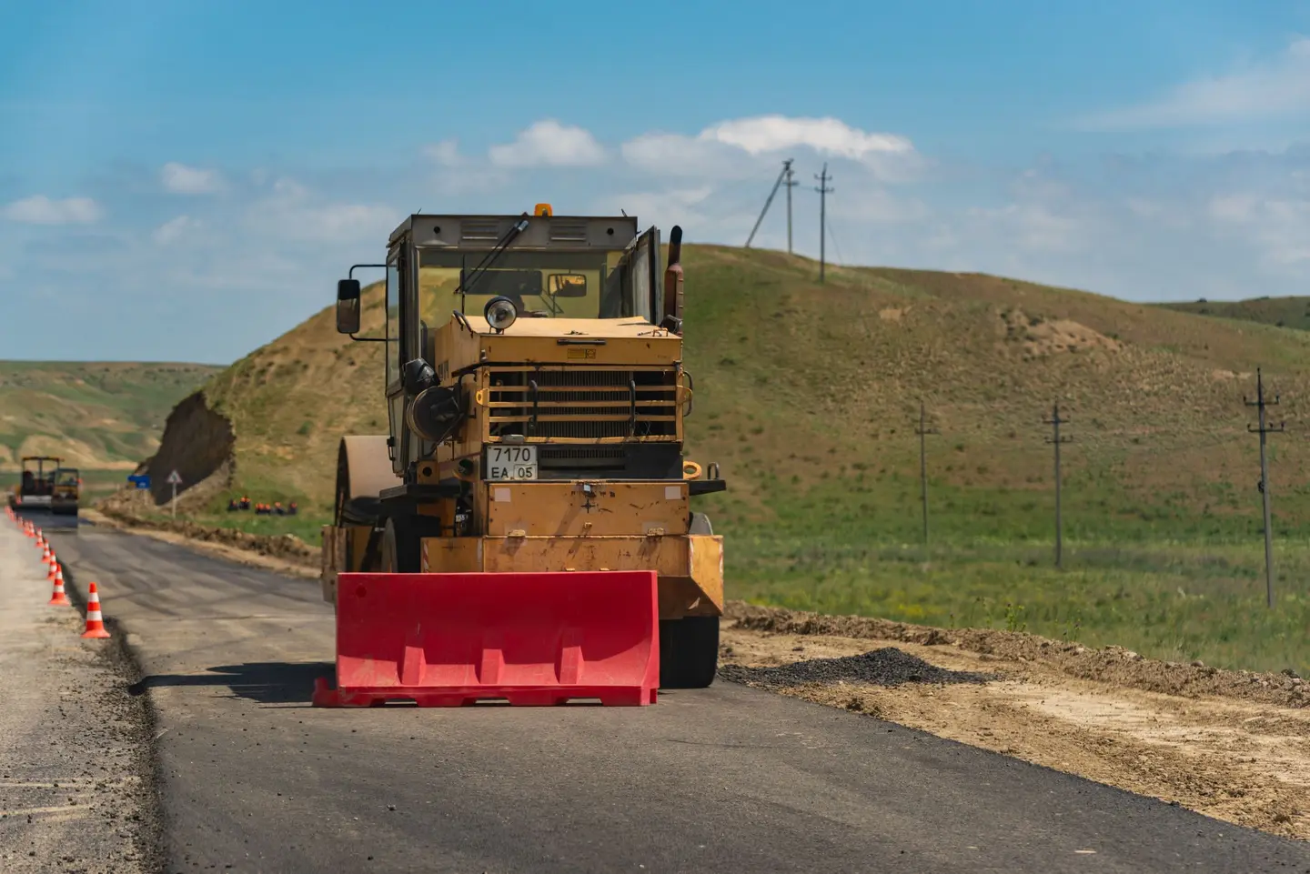 Illustrative scene, not evidence for this record: A road roller on a rural road.