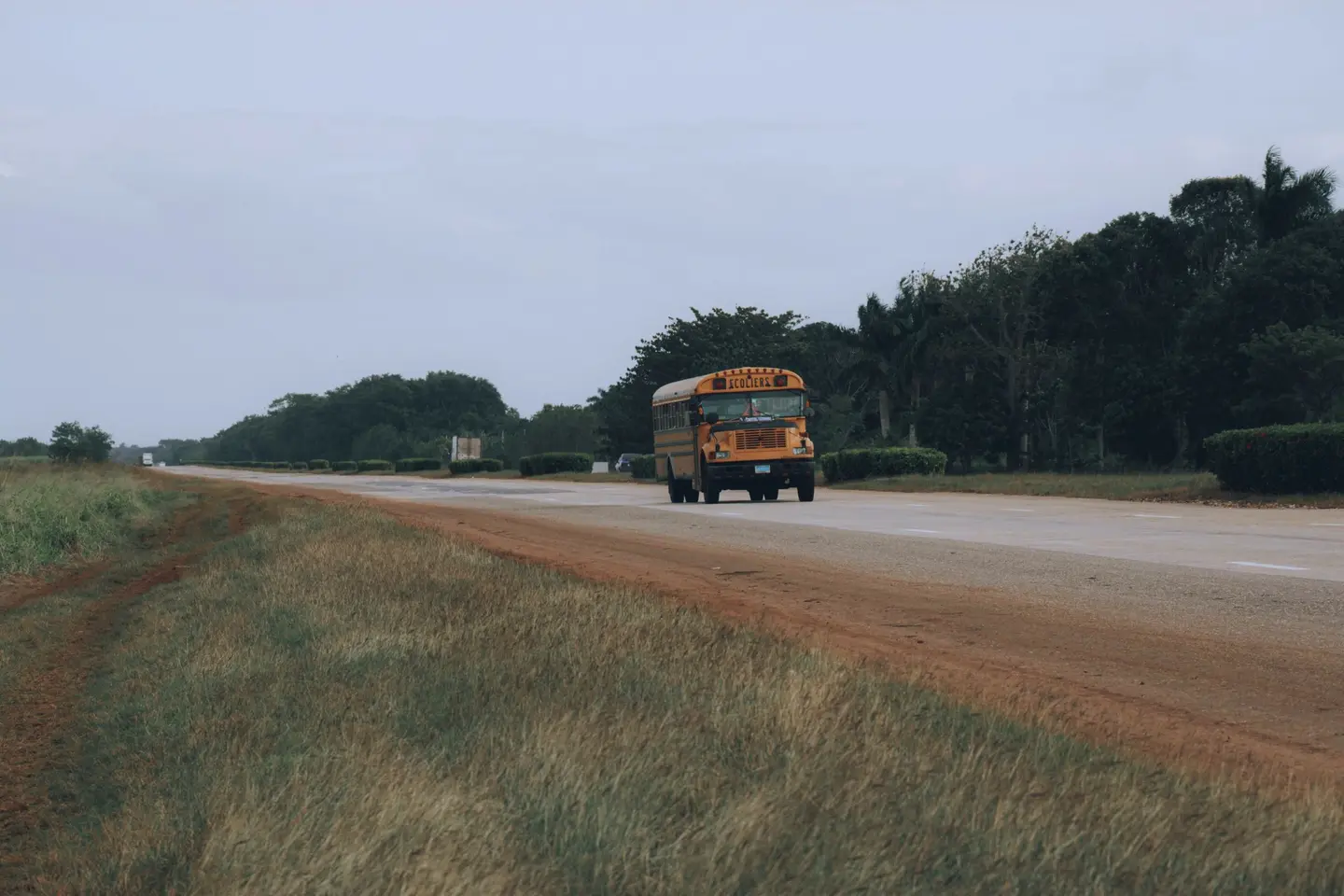 Illustrative scene, not evidence for this record: A school bus on a rural road.