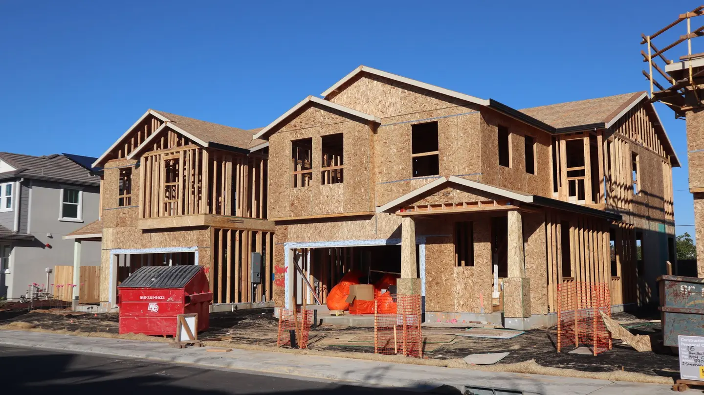 Illustrative scene, not evidence for this record: New houses under construction in a subdivision.