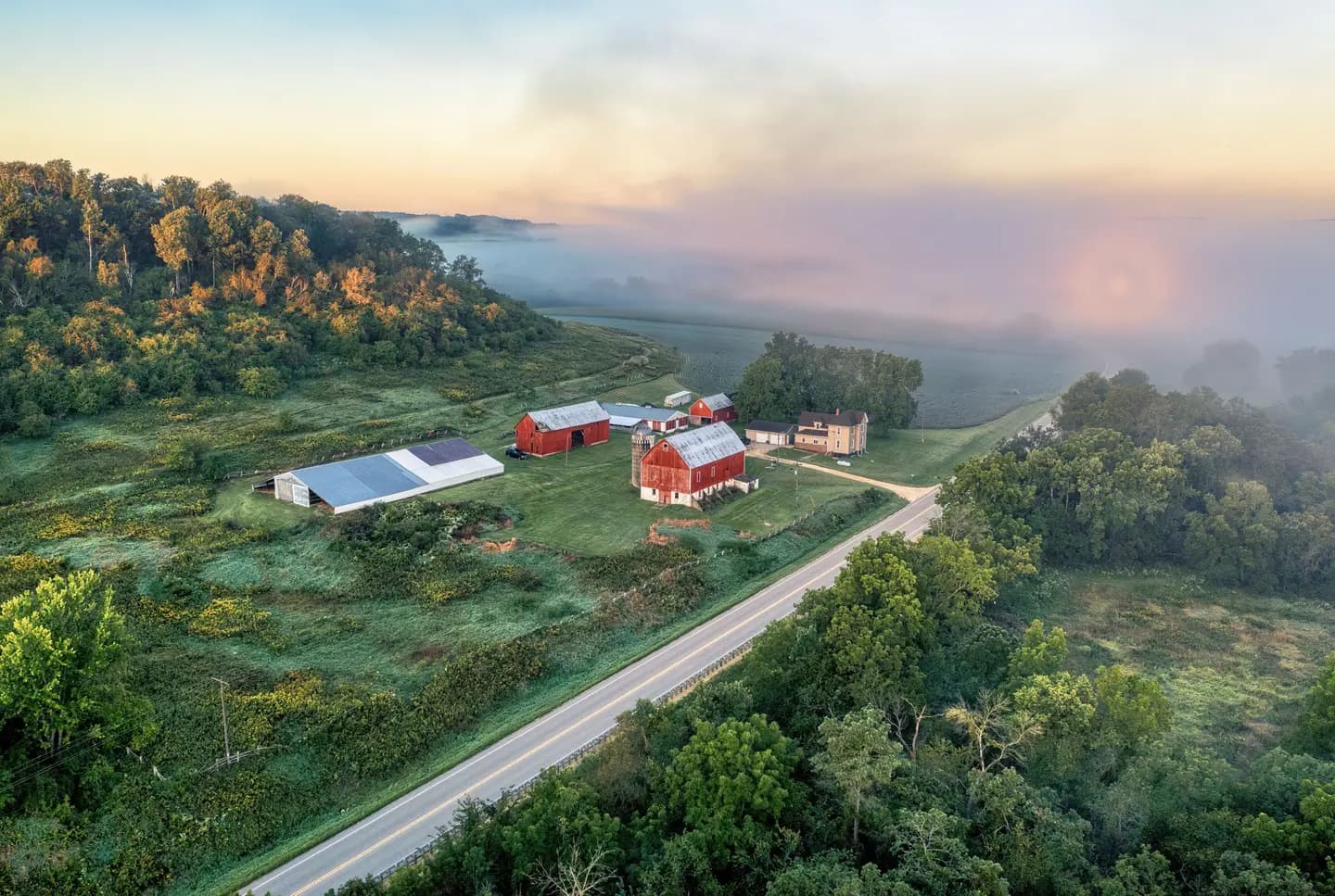Illustrative scene, not evidence for this record: A farm at sunrise near Tell, Wisconsin.