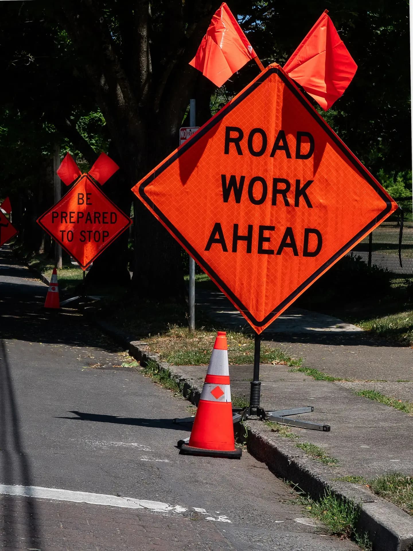 Illustrative scene, not evidence for this record: A road work ahead sign and cone.